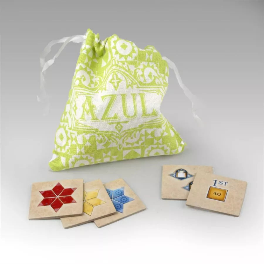 A photo of the Objective Tiles mini expansion, for use with the board game Azul Summer Pavilion. The photo displays a cloth drawbag with square cardboard tiles around it, on a plain white background.