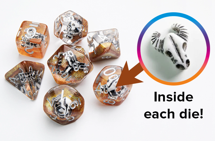 An overhead photo of seven Embraced Dice from Gamegenic, and a close up of a horned skull token that is embedded in the center of each die.