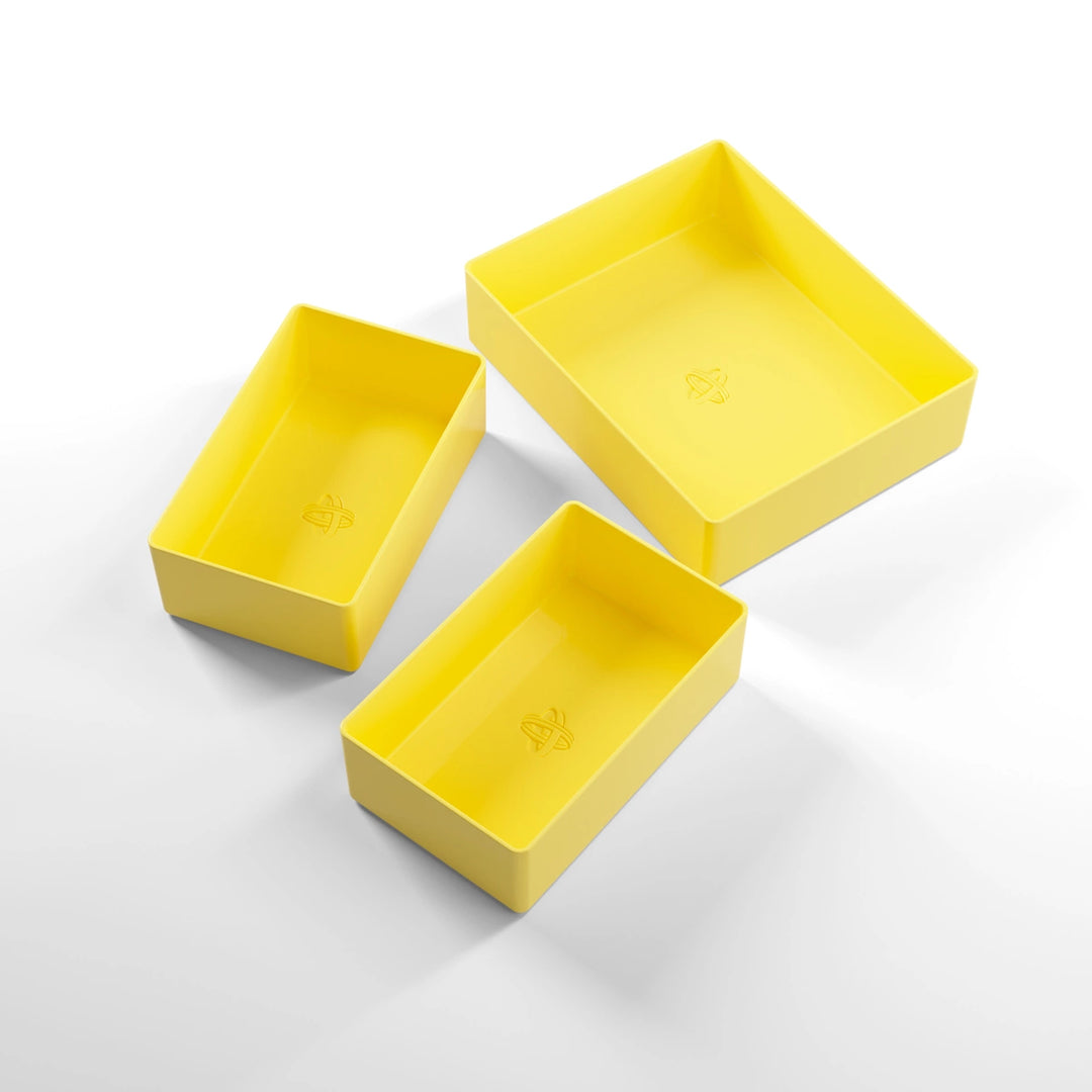 A photo of three, yellow, plastic containers, two small and one large, on a white background.