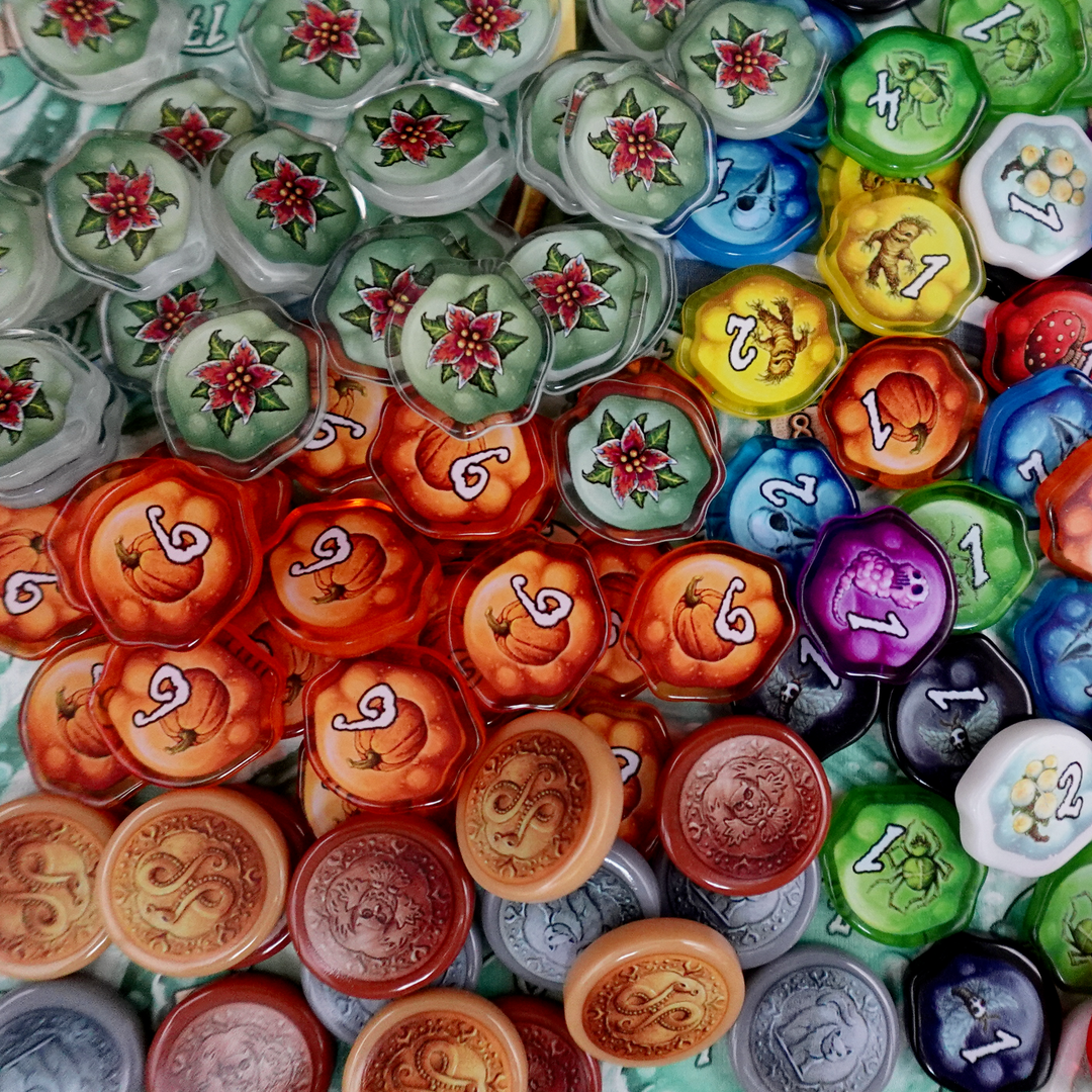 A photo of plastic, transparent upgrade tokens for use with the board game Quacks of Quedlinburg.