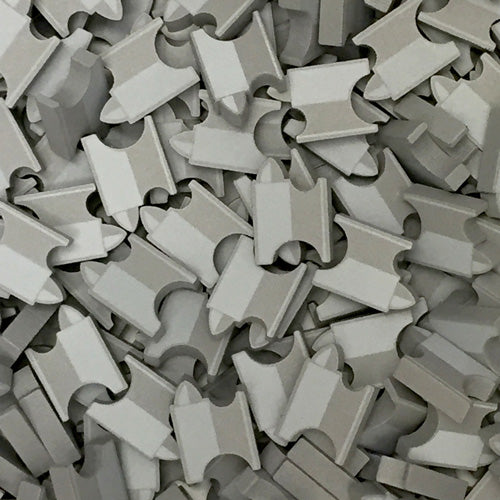 A photo of a pile of wooden anvil shapes.