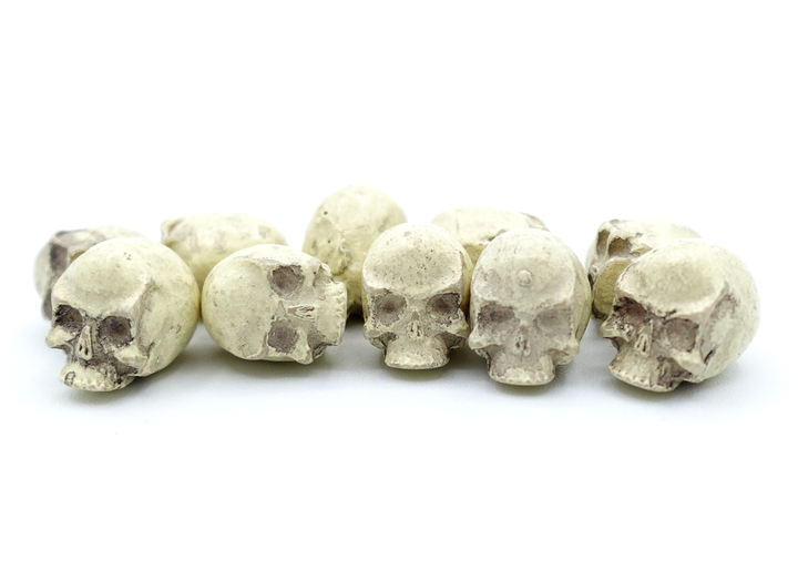 A close-up photo of a set of ten resin skulls on a white background.