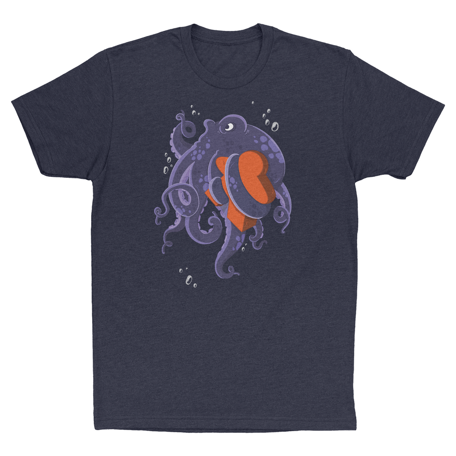 A photo of a navy t-shirt, with a picture of an octopus holding a wooden, orange board piece shaped like a person.