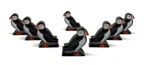 Eight identical, painted, wooden tokens of a puffin, for use with the board game Wingspan.
