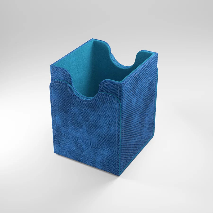 A photo of a blue, fabric box on a white background with the lid removed and attached to the bottom of the box. The box is empty inside.