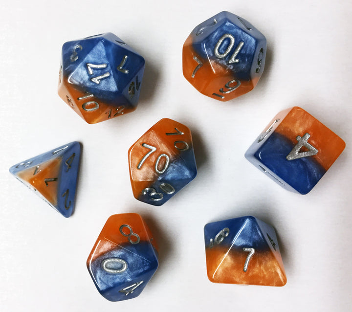 A group of separated, swirled orange and blue dice, all different shapes, on a white background.