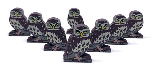 Eight identical, painted, wooden tokens of a little owl, for use with the board game Wingspan.