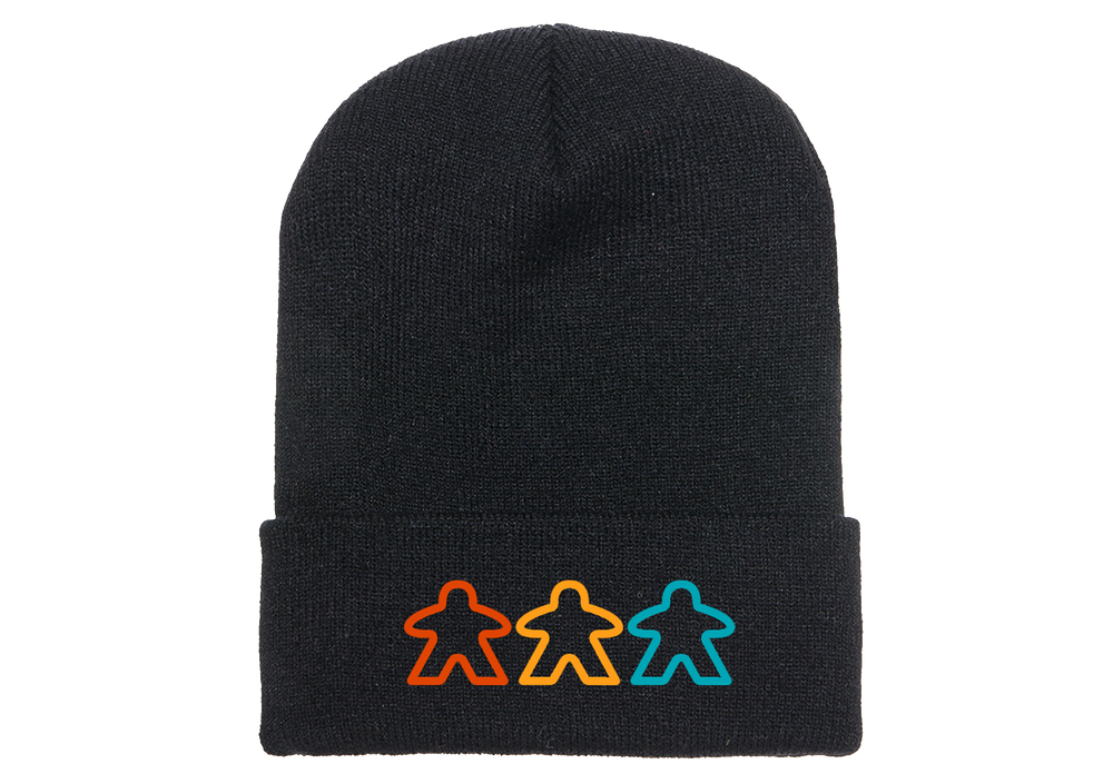 A photo of a black knit skicap, with an embroidered decoration of three, outlined meeples in various colors at the bottom. 