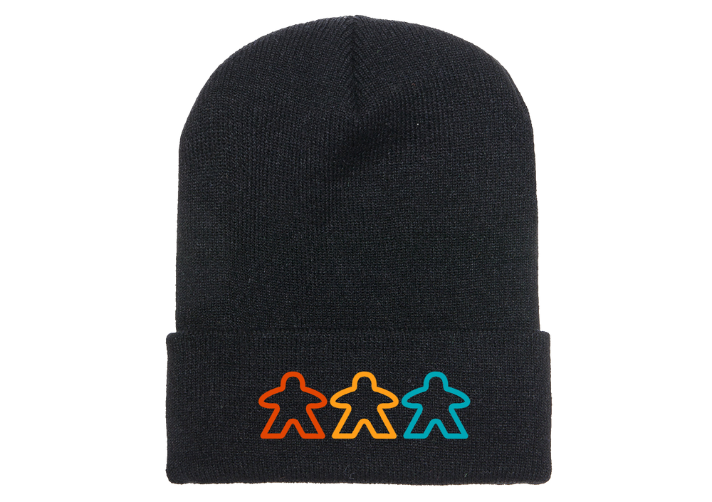 A photo of a black knit skicap, with an embroidered decoration of three, outlined meeples in various colors at the bottom.