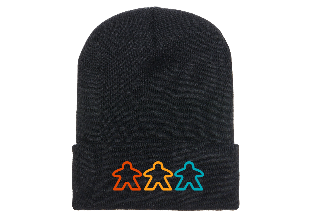 A photo of a black knit skicap, with an embroidered decoration of three, outlined meeples in various colors at the bottom.