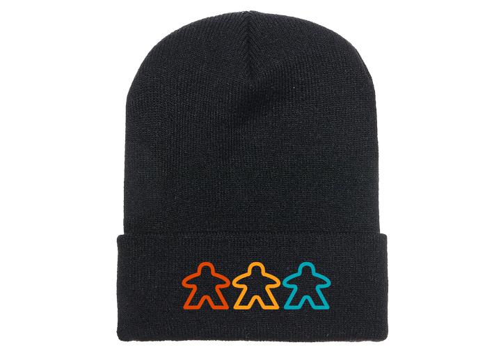 A photo of a black knit skicap, with an embroidered decoration of three, outlined meeples in various colors at the bottom.