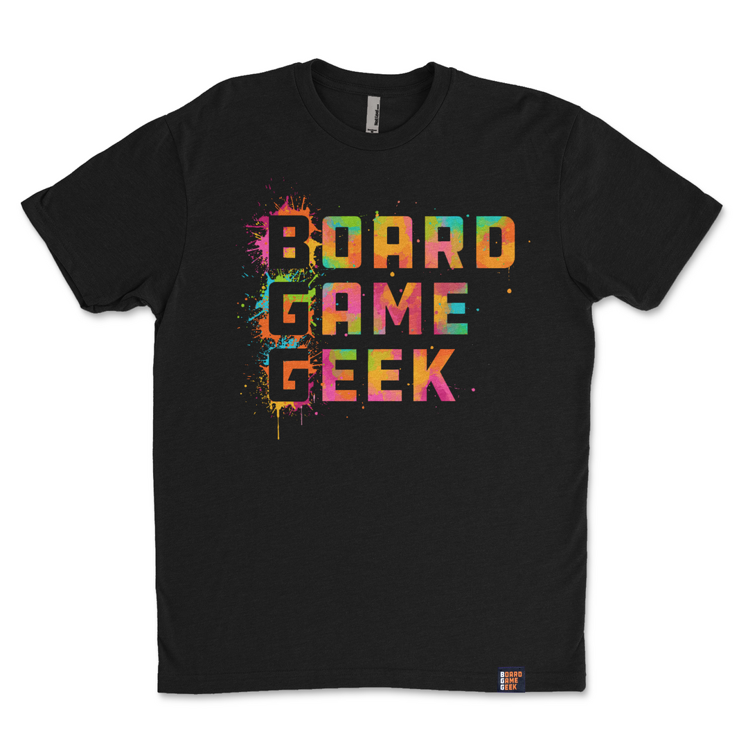 A photo of a black t-shirt, featuring the words "BoardGameGeek" written in colorful, splattered paint.