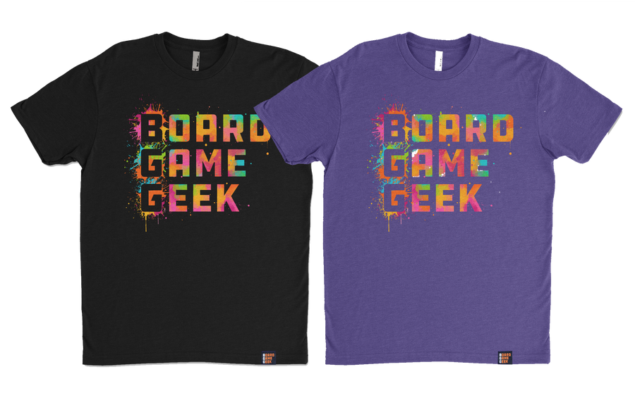 A photo of two shirts, one in black and one purple, both the words "BoardGameGeek" written in colorful, splattered paint.