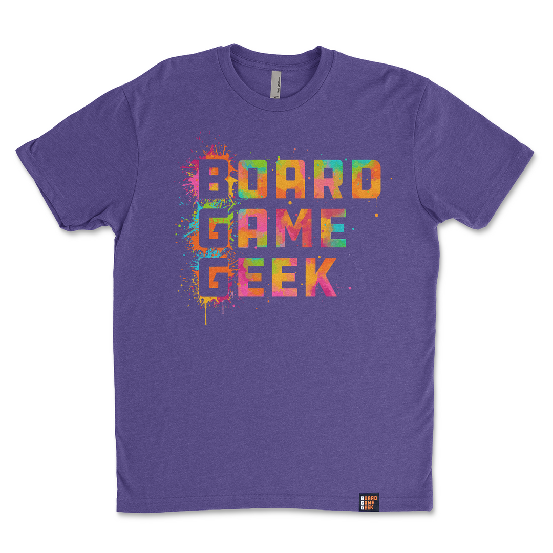 A photo of a purple t-shirt, featuring the words "BoardGameGeek" written in colorful, splattered paint.