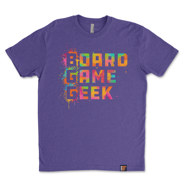 A photo of a purple t-shirt, featuring the words "BoardGameGeek" written in colorful, splattered paint.
