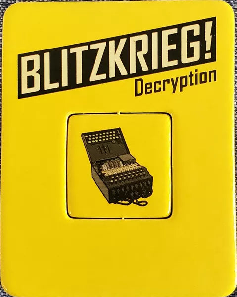 A photo of the Decryption promo for use with the board game Blitzkrieg!, which is a single cardboard punchboard showing an Enigma machine on a yellow background.