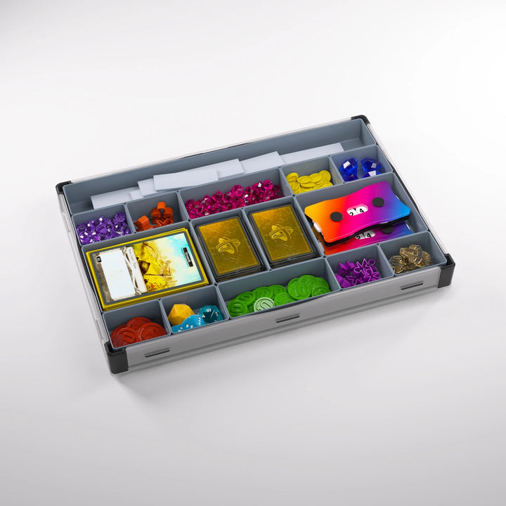 A photo of a black and gray container, with many smaller containers, each holding a variety of board game accessories and supplies. The lid is removed from the container and clipped to the bottom.