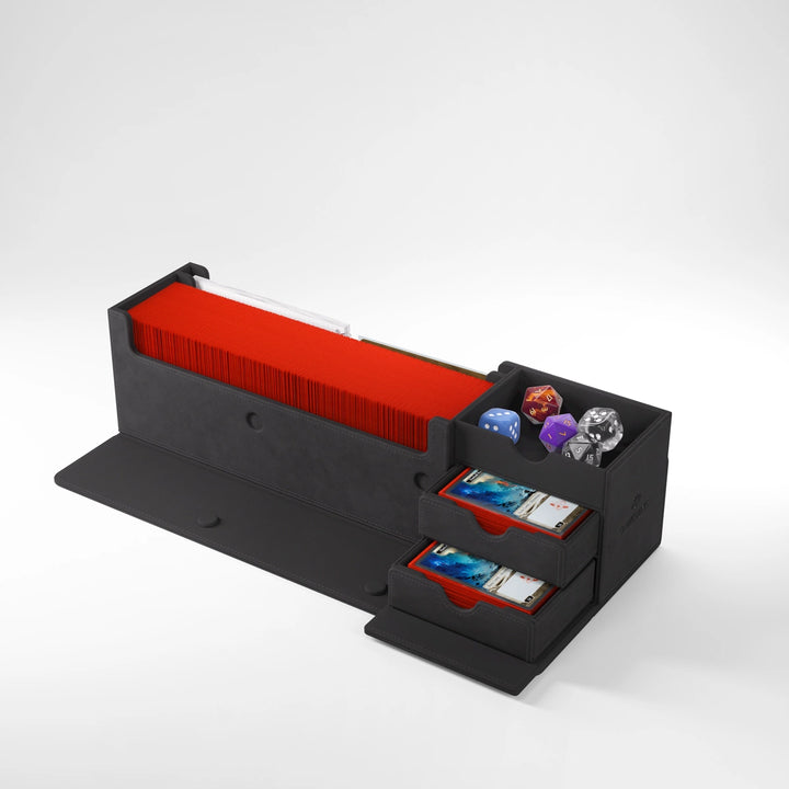 A photo of the black version of the Cards' Lair 400 deck box, made by Gamegenic, featuring a long compartment filled with stacked cards, a smaller compartment with a variety of dice, and two extended drawers.