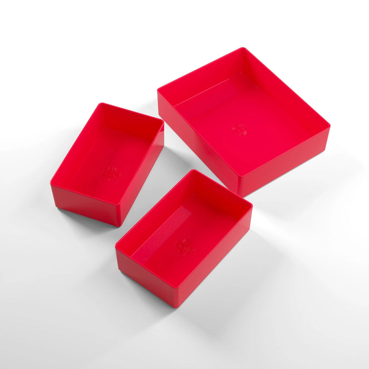 A photo of three, red, plastic containers, two small and one large, on a white background.