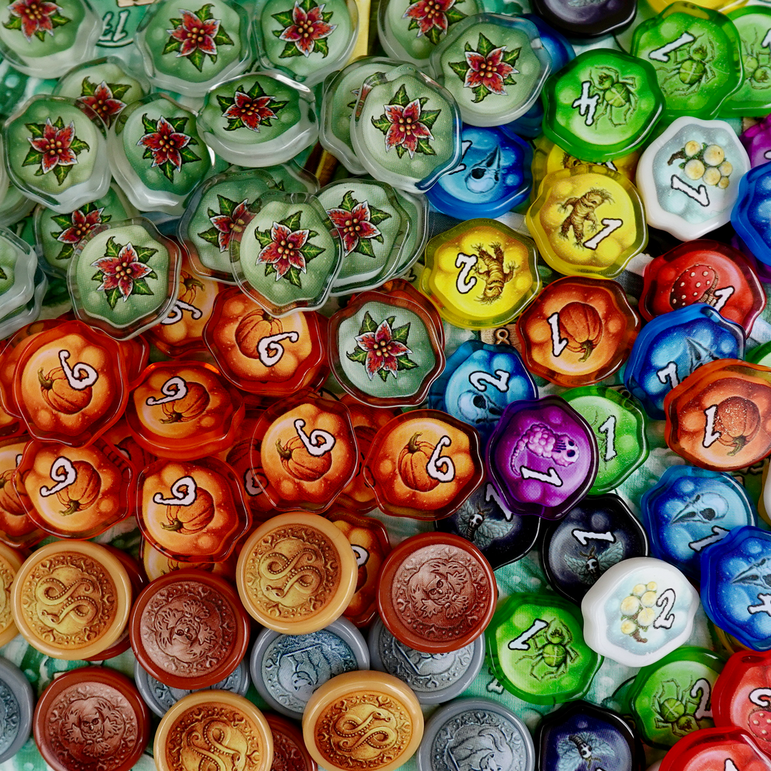 A photo of plastic, transparent upgrade tokens for use with the board game Quacks of Quedlinburg.
