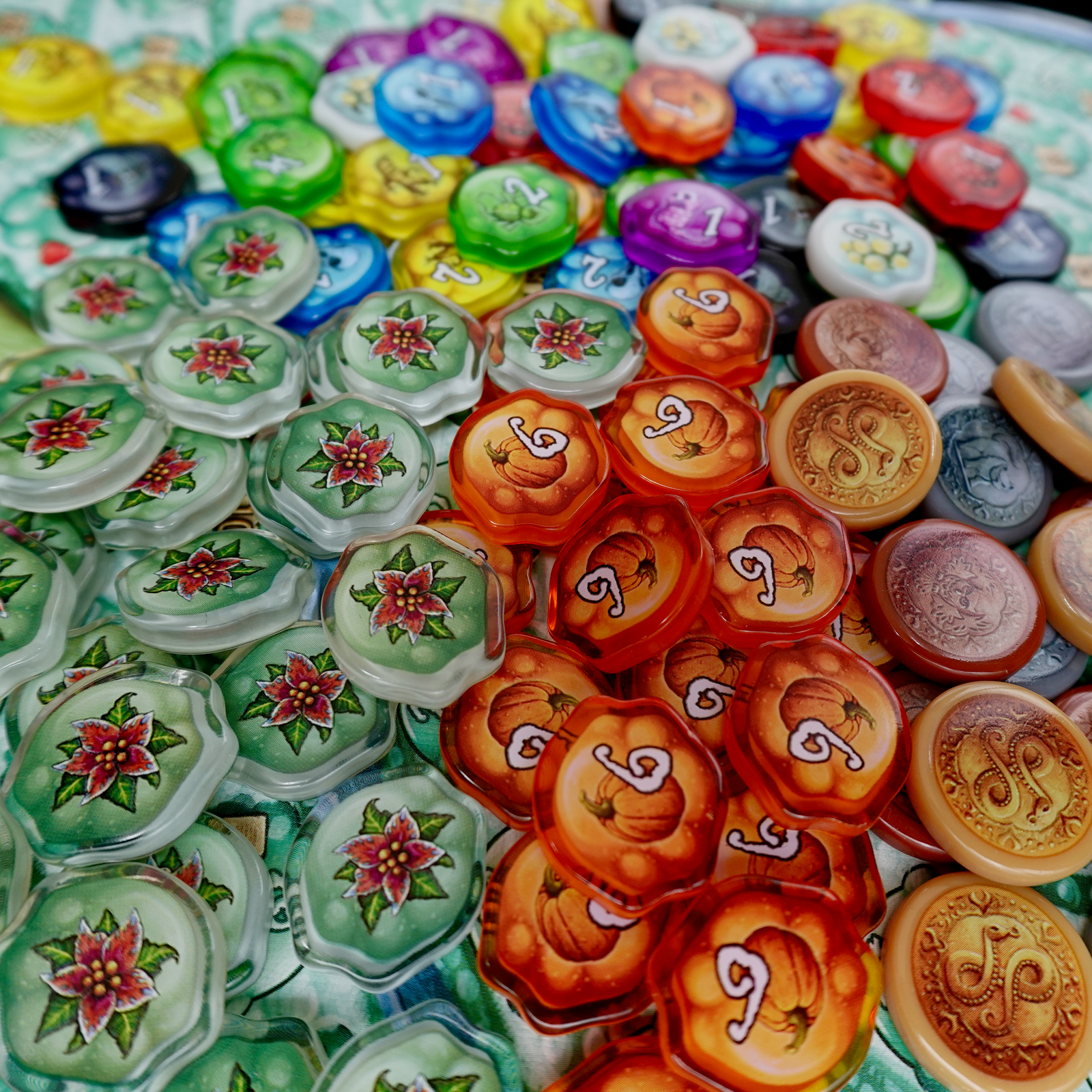 A photo of plastic, transparent upgrade tokens for use with the board game Quacks of Quedlinburg.