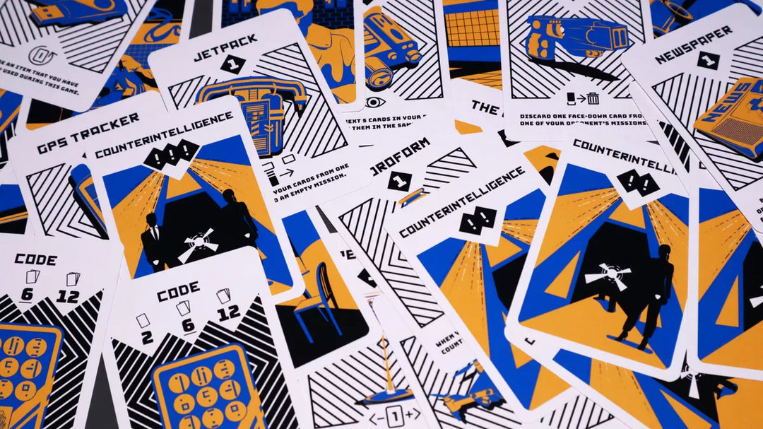 A jumble of cards from the board game Kompromat, featuring spy-themed artwork in black, white, blue, and orange.