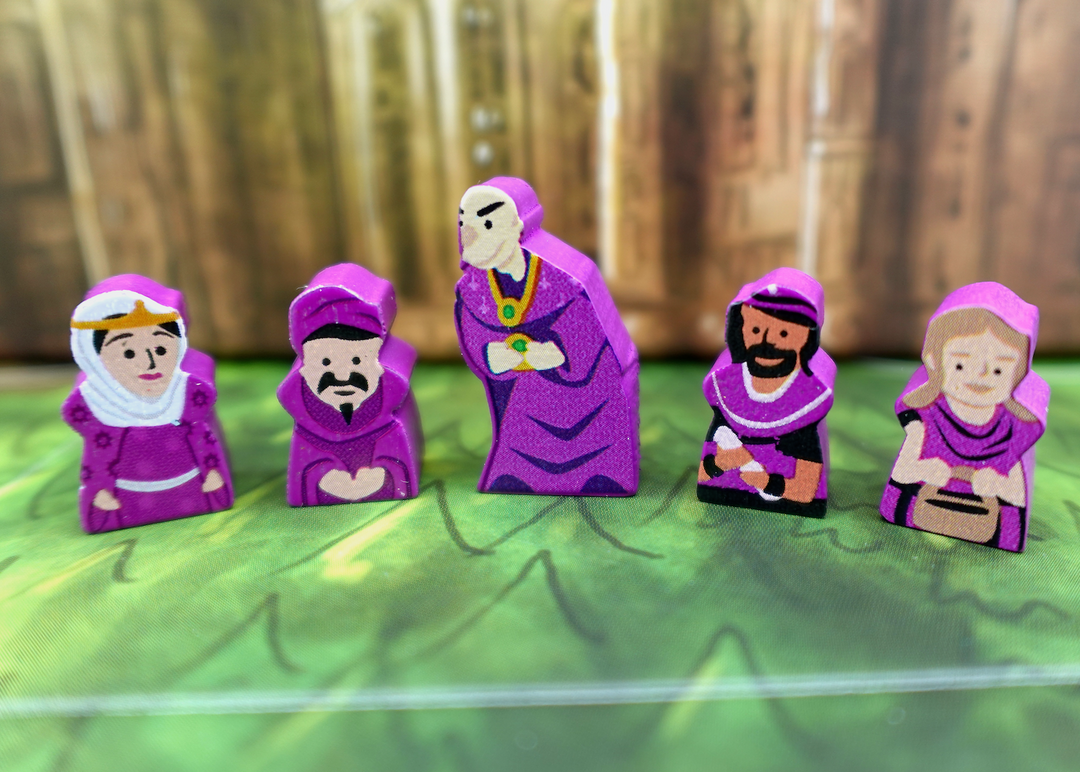A close up photo of five wooden people tokens made from wood, with faces and clothes painted on one side, and the sides painted purple.