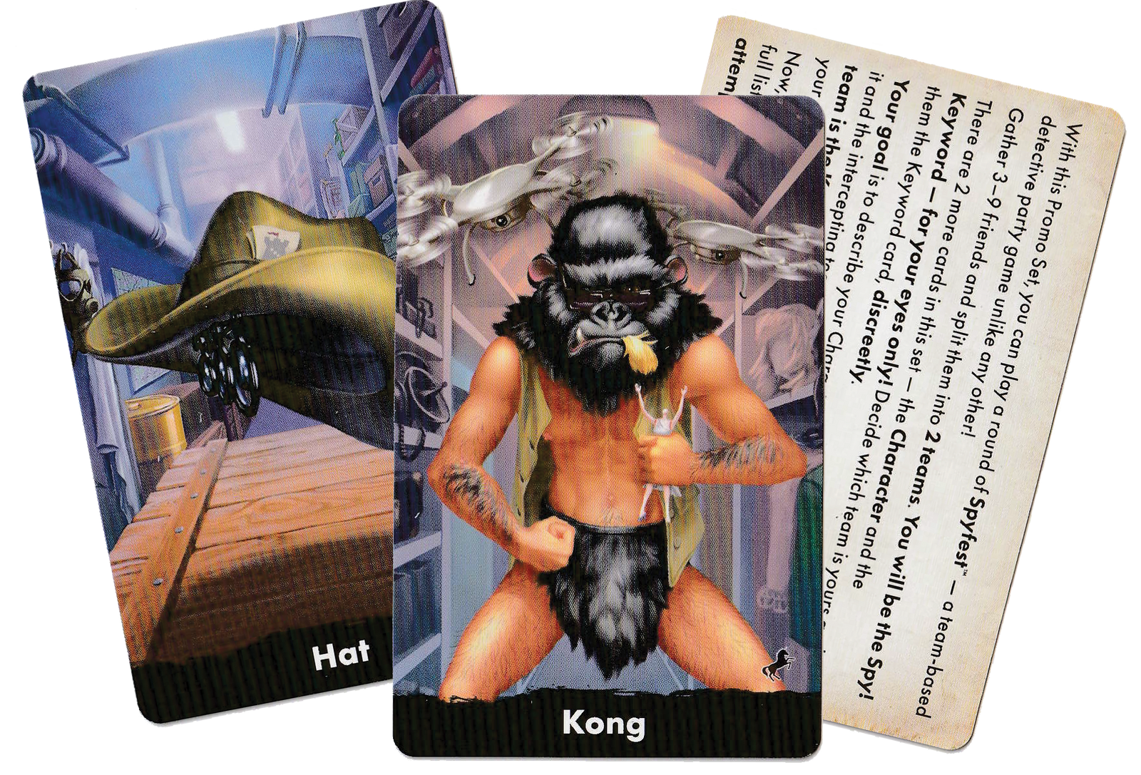 A set of three cards for use with the board game Spycon. The first card features an illustration of a hat, the second card features an illustration of a man wearing a gorilla mask and fur loincloth, and the third card contains text instructions for the promo's use.