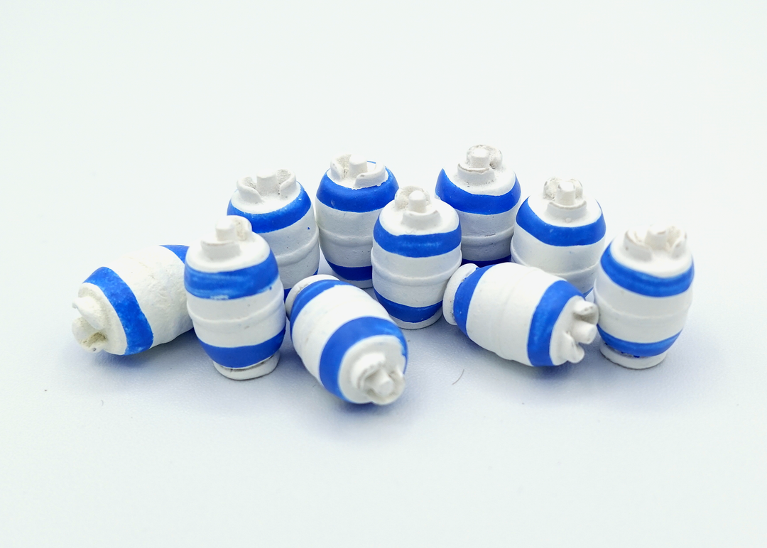 A close up photo of a group of tokens shaped and painted to look like containers for natural gas, sitting on a white background.