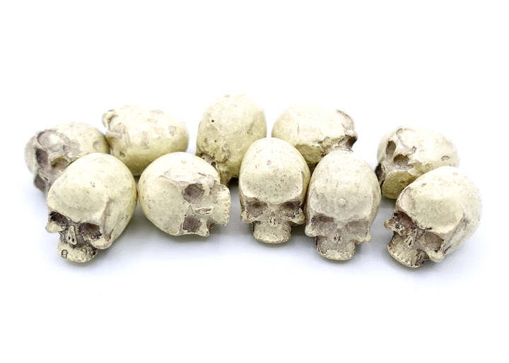 A close-up photo of a set of ten resin skulls on a white background.