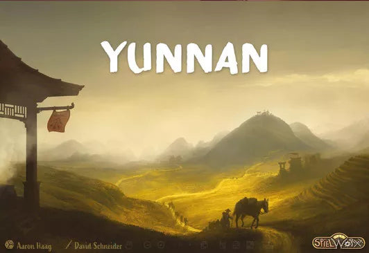 The front cover of the board game Yunnan, featuring an illustration of foggy and hilly landscape, with a horse pulling a cart and the front corner of a building in the foreground.