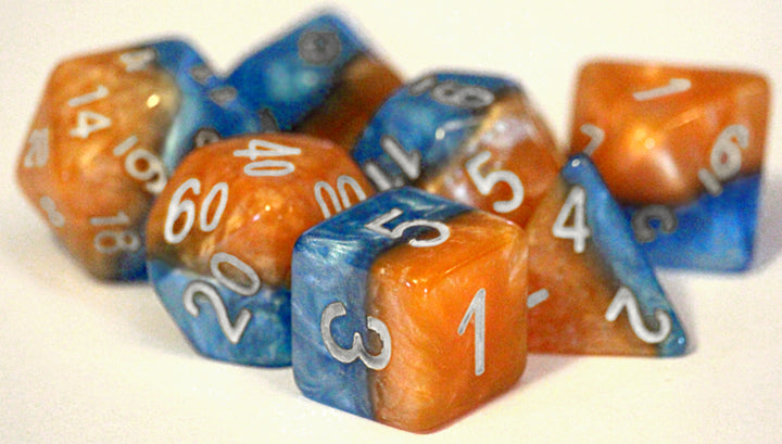 A pile of swirled orange and blue dice, all different shapes, on an off-white background.