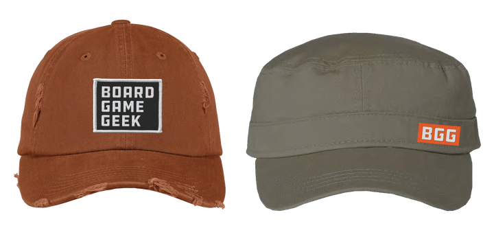 Two caps, side by side. One is burnt orange with intentional distressing and a black-and-white patch that says "BoardGameGeek" in the front center. The second hat is olive green and has a small orange and white label on the right side that says "BGG".