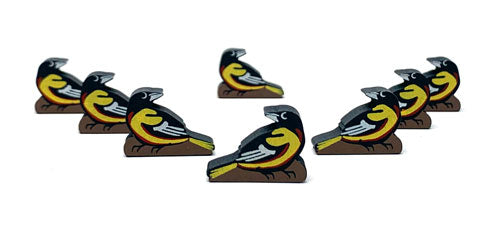Eight identical, painted, wooden tokens of a goldfinch, for use with the board game Wingspan.