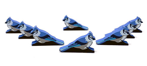 Eight identical, painted, wooden tokens of a blue jay, for use with the board game Wingspan.