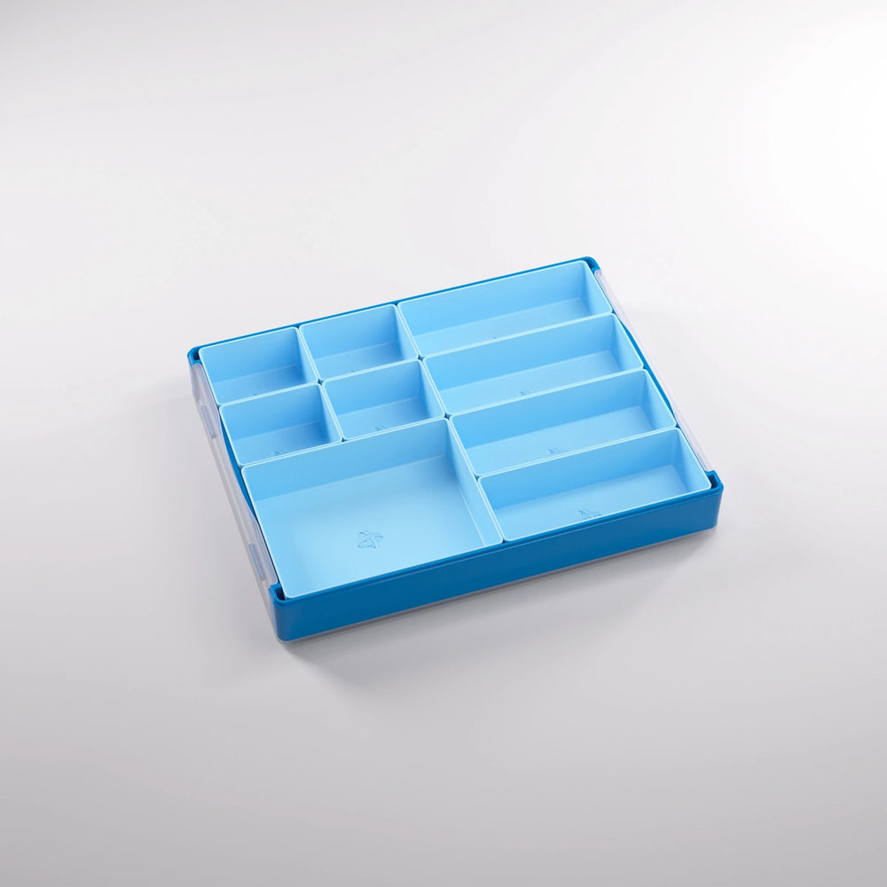 A photo of a empty, blue, plastic container on a white background. Inside of this container are smaller sections of various sizes.