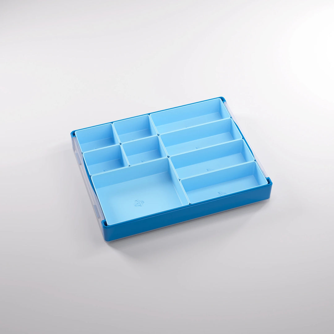 A photo of a empty, blue, plastic container on a white background. Inside of this container are smaller sections of various sizes.