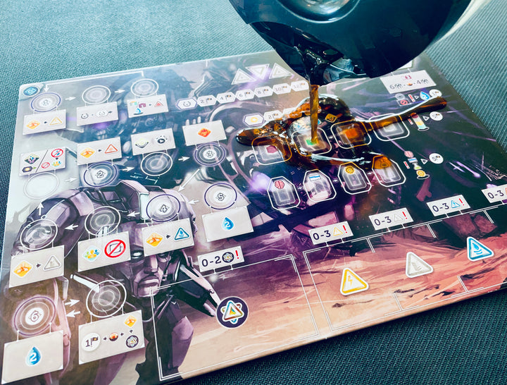 A photo of coffee from a coffee pot getting poured on a cardboard player board from a board game.
