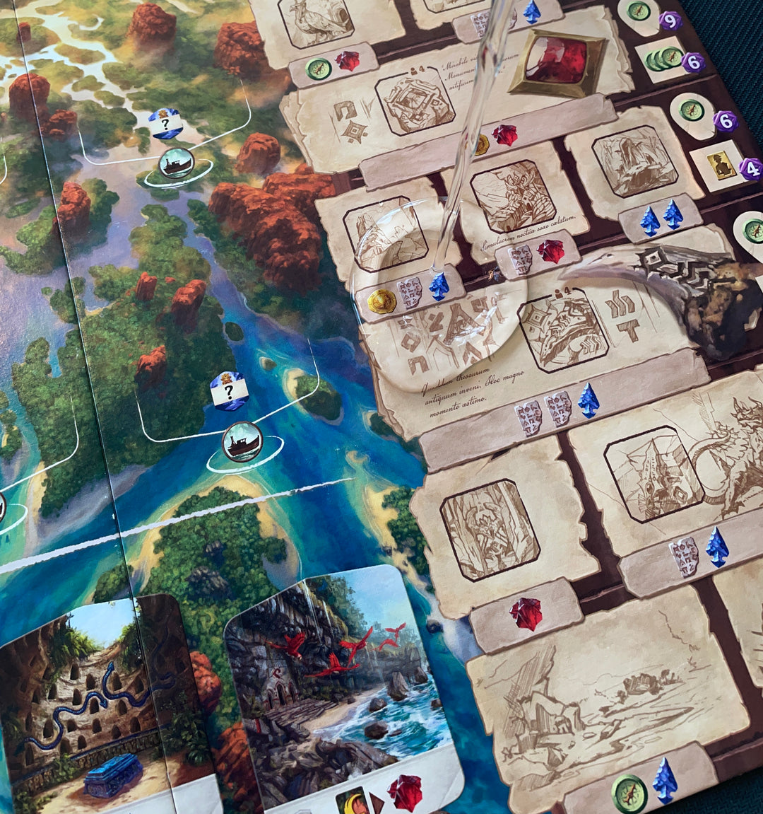 A close up of a game board from a board game, with a stream of water hitting the game board from above.