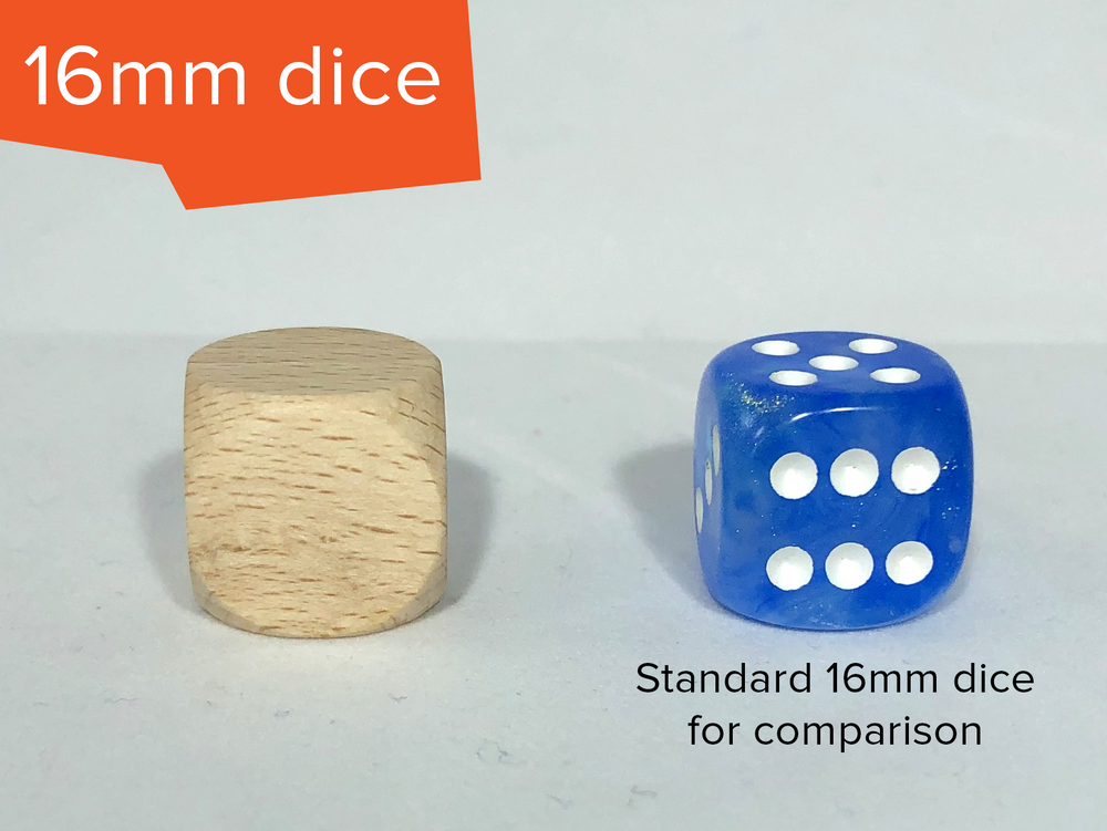 A blank, unfinished wooden die sitting next to a blue and white D6 die. The photo is labelled "16mm dice" in the top left, and "standard 16mm dice for comparison" under the blue die. The dice are the small size.