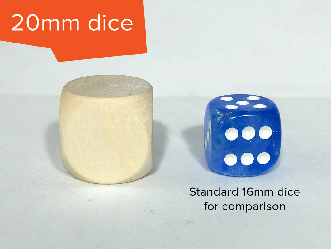 A blank, unfinished wooden die sitting next to a blue and white D6 die. The photo is labelled "20mm dice" in the top left, and "standard 16mm dice for comparison" under the blue die. The wooden die is larger then the blue die.