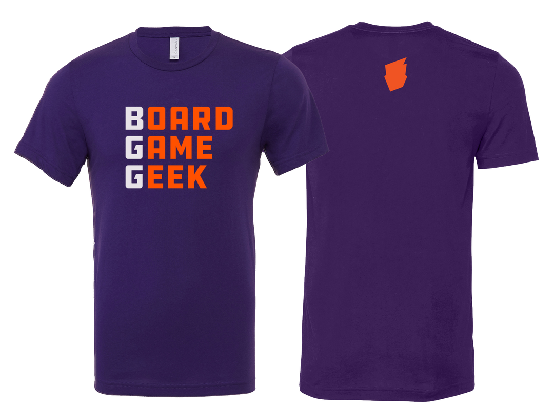 A picture of the front and back of a purple t-shirt. On the front, the shirt is printed with the words "BoardGameGeek", with "BGG" in white letters and the rest in orange letters. On the back, the BoardGameGeek logo is pictured in orange on the upper center on the shirt.